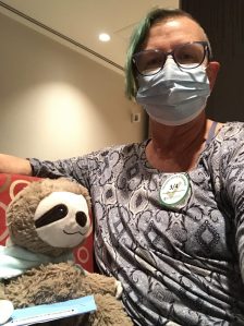 cancer patient with companion stuffed sloth